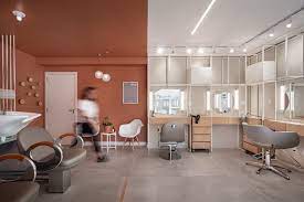 The beautifully minimal beauty salon has a clean 'modern retro' aesthetic with contemporary, geometric furnishings and hanging light fixtures. H It Beauty Salon Danielle Martins Arquitetura Archdaily