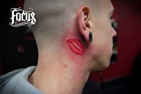 red lips kiss tattoo below ear tattoo