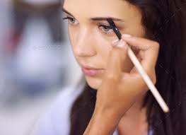 young woman having makeup applied