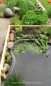 small pond in a raised garden bed