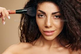 curly latin makeup artist hold brush