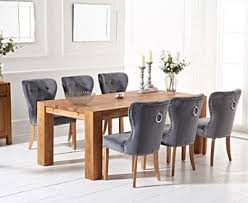 The sleek, sophisticated style of this reclaimed wood table would look fabulous in any modern kitchen or dining room. Madrid 240cm Solid Oak Dining Table With Knightsbridge Velvet Chairs Madrid