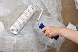 Painters Hand Holds Paint Roller