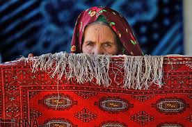 rural women in iran weaving carpets