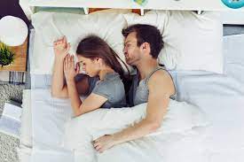 Young Couple Sleeping In Bed Stock