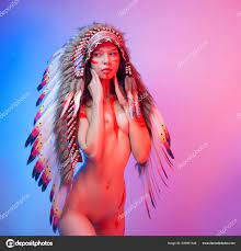 Naked woman in native american costume with feathers on a neon background  Stock Photo by ©artrotozwork 505801348