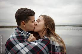 portrait of cute young couple kissing