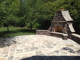 grand stone outdoor fireplace in