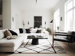 white couch and a black and white rug