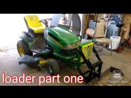 front end loader on a riding lawn mower