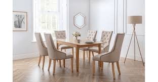 The saw cut oak marquetry tops are the beautiful padded dining chairs are upholstered in a slate grey velvet and features a beautiful stud detail around the edge of the seat just adding to its stylish appeal. Cotswold Extending Dining Table And 6 Loire Chairs The Place For Homes