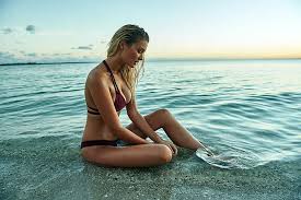 model sitting on the beach