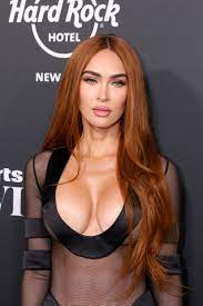 Megan Fox's breasts nearly pop out of dress at Sports Illustrated party
