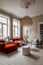 warm colors and a stylish red sofa a
