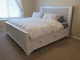 white wooden kingsize bed with storage