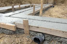 pour concrete footings for stone walls