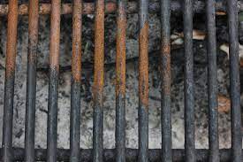 grilling with charcoal in a rusty grill