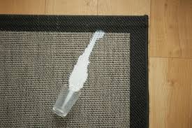 gl of milk spilled on gray carpet