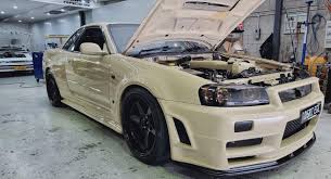 tan colored nissan skyline r34 gt r