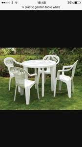 white plastic garden table and 4 chairs
