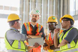 Construction Workers Looking At Digital Tablet Stock Photo - Download Image Now - Construction Industry, Construction Site, Construction Worker - iStock