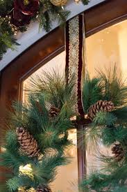 This creates an invisible hanging wreath effect that has a finished and grand look! Easy Trick To Hanging Door Wreaths With Ribbon Bluegraygal