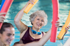 senior woman doing aqua aerobic aw
