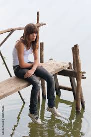 lonely sad teenage girl sitting on the