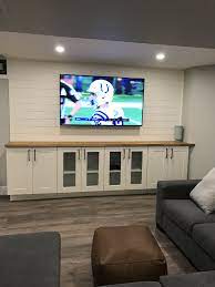 A popular choice for basement bar cabinets is the white shaker. Tv With Shiplap Great Look To A Finished Basement 10 Ft Wide 65 Inch Tv Ikea Narrow Cabinets Basement Living Rooms Basement Family Rooms Home