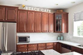 Use books to decorate above kitchen cabinets use books as decor! Decorating Above Kitchen Cabinets Craving Some Creativity
