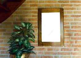 Hanging Wooden Frame On Brick Wall With
