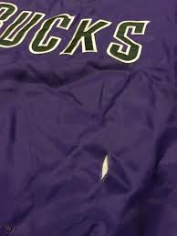 Silver buck antlers and a green basketball on a purple triangle with silver and green outline. Vintage Milwaukee Bucks Starter Jacket Pullover Purple Size Xl Nba 90s Old Logo 1829264643