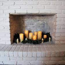 A Fireplace Mantle With Flameless Candles