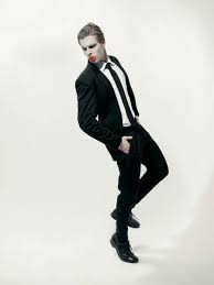 male model with art makeup wearing suit