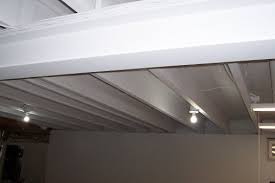 But turning a cold basement into a cozy spot isn't impossible! How To Paint A Basement Ceiling With Exposed Joists For An Industrial Look