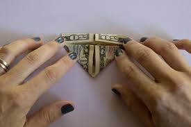 Then, fold it in half diagonally the other way and unfold it again. How To Fold A Dollar Bill Into An Origami Heart Hgtv