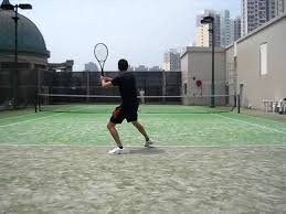 tennis rally on outdoor carpet surface