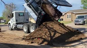 dump truck delivering top soil compost