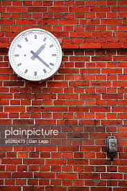 Clock Hanging On Brick Wall