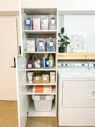 organizing a deep laundry cabinet