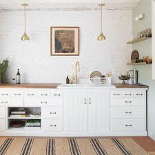 The bright white shaker cabinets pop against black countertops and black brick backsplash. How To Choose Cabinet Hardware Schoolhouse