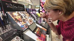 woman testing makeup in macys