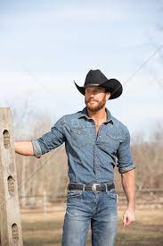 handsome rugged cowboy on a ranch rob