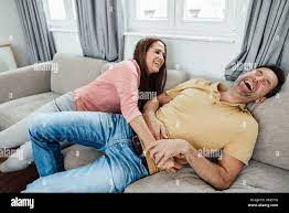 Woman tickling man hi-res stock photography and images - Alamy