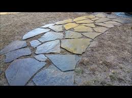diy laying out flagstone walkway with