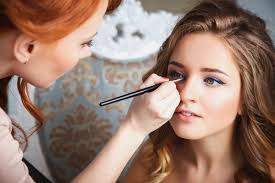 makeup artist preparing bride before