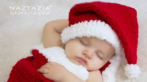 Little boy wearing a santa hat and playi. Santa Hat And Cocoon Naztazia