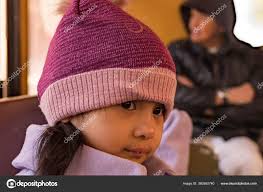 pretty female child wearing purple coat