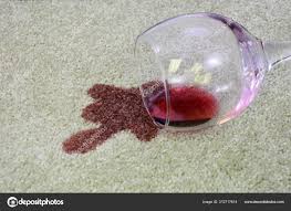 spilt red wine on carpet stock photo by