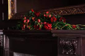 A fake flowers arrangement on a fireplace mantel 3258004 Stock Photo at  Vecteezy